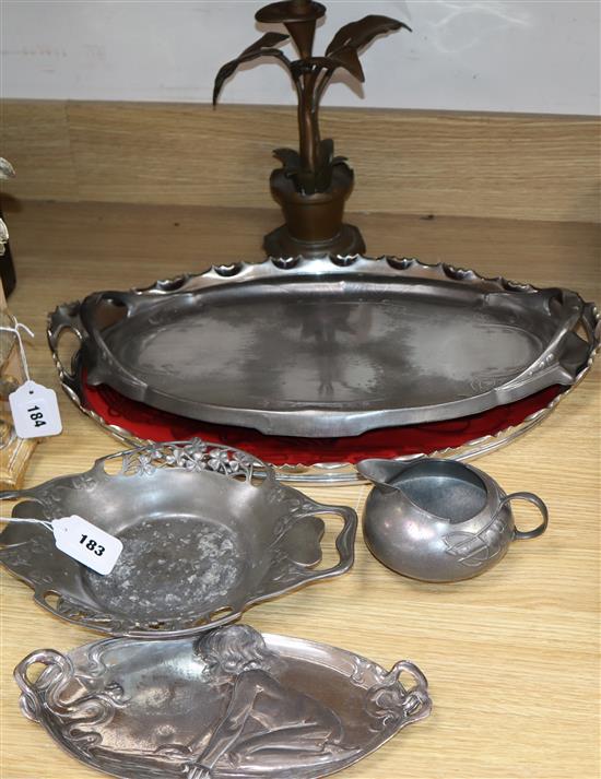 A Liberty Tudric dish and jug, a WMF tray, a Kayserzinn tray and one other, and a candlestick